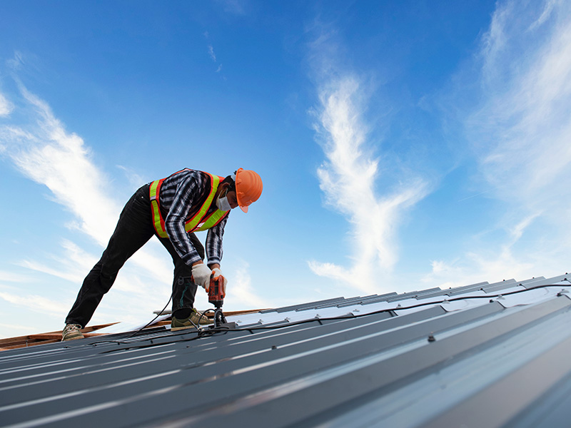 roofer working on a commercial roof prior lake mn